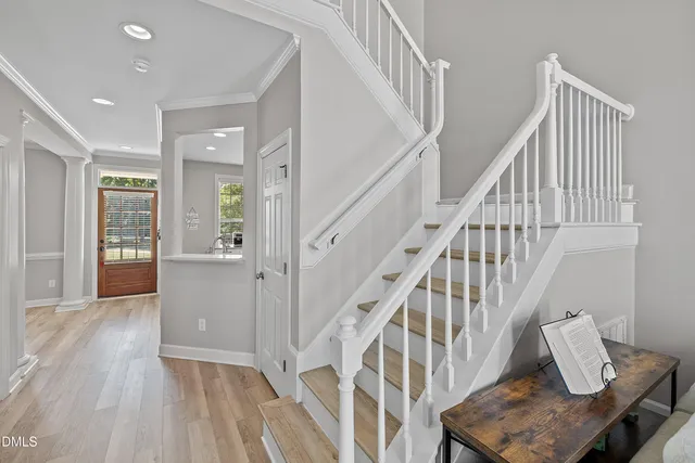 a living room with furniture and stairs