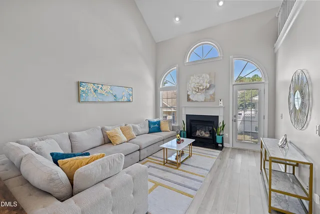 a living room with furniture a fireplace and a window