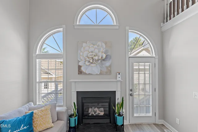 a dining room with wooden floor and a chandelier