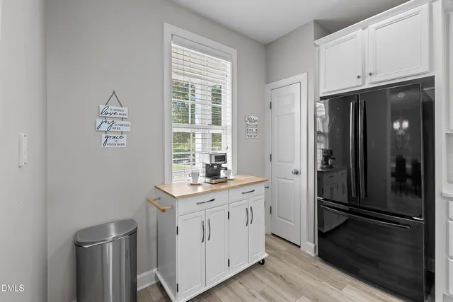 a kitchen with granite countertop a refrigerator stove and sink