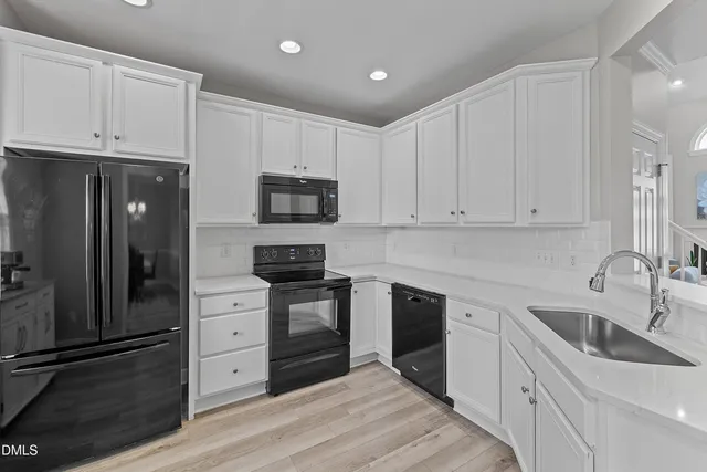 a stove top oven sitting inside of a kitchen