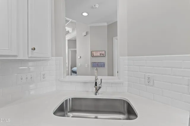 a bathroom with a granite countertop toilet a sink and mirror