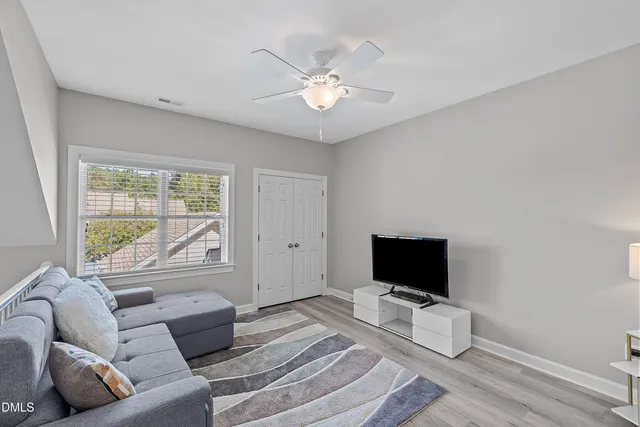 a front view of a house with a yard and potted plants
