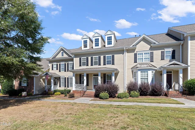 a front view of a residential houses with yard