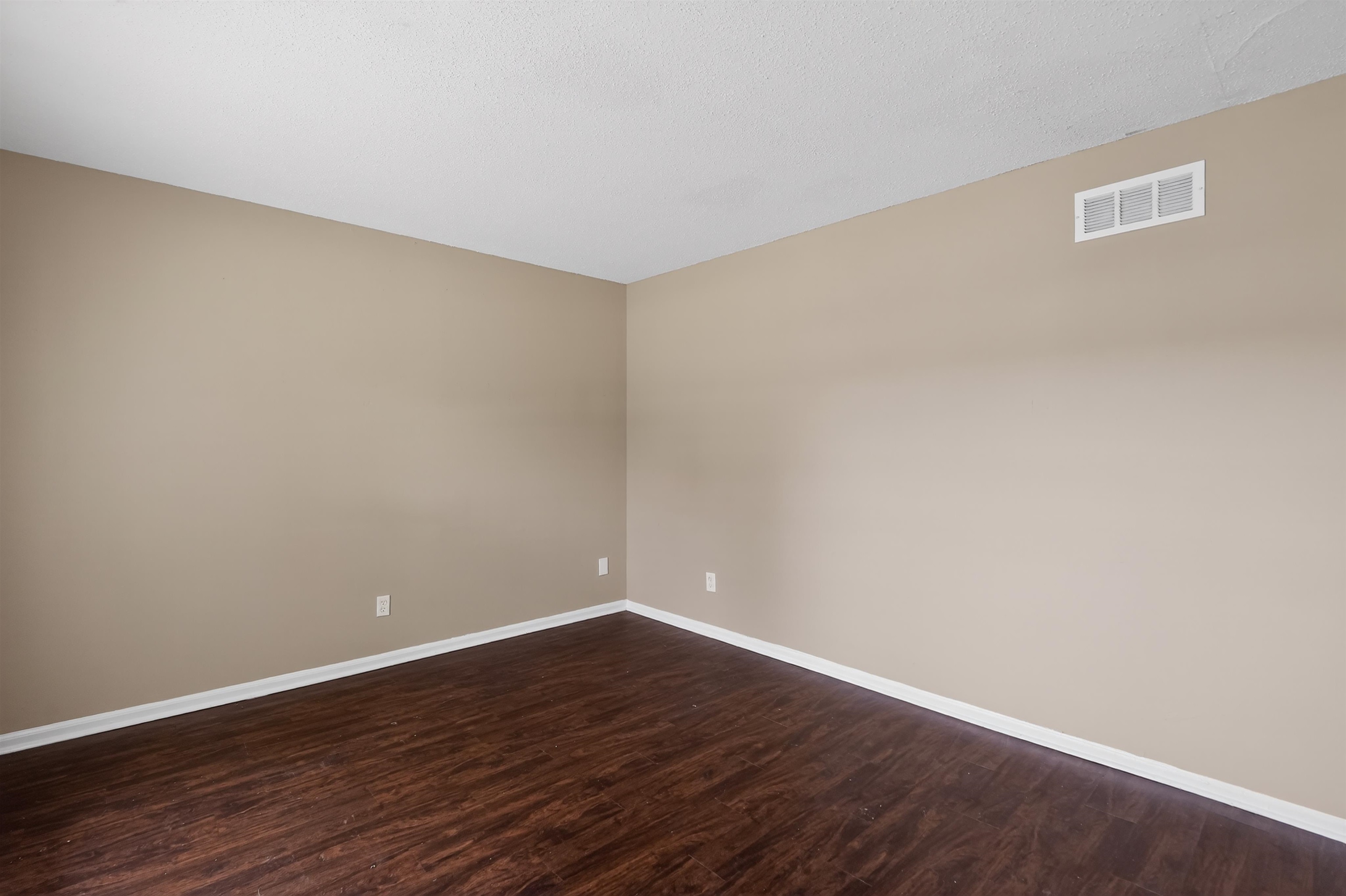 3608 Cane Ridge Drive Memphis, TN 38109 - Photo 14 of 31 Interior space featuring wood-finish flooring, neutral wall paint, white trim, and a ceiling-mounted HVAC vent