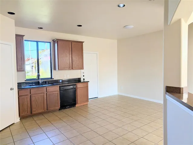 a view of a kitchen with a sink and a refrigerator