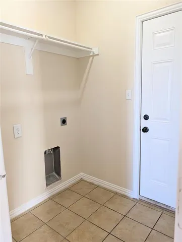 a view of a hallway with wooden floor and entryway