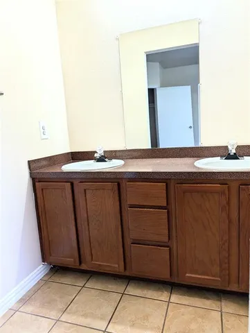 an empty room with wooden floor and cabinet