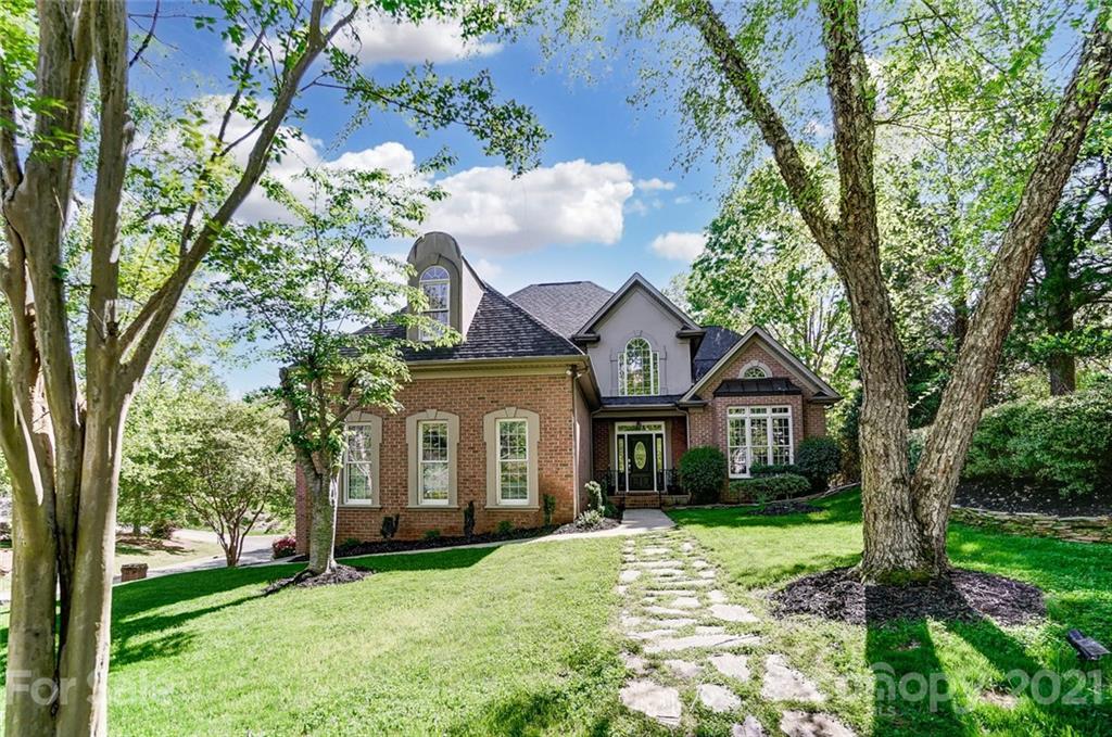 7126 Topsail Circle Tega Cay, SC 29708 - Photo 1 of 48 a front view of a house with a garden and trees