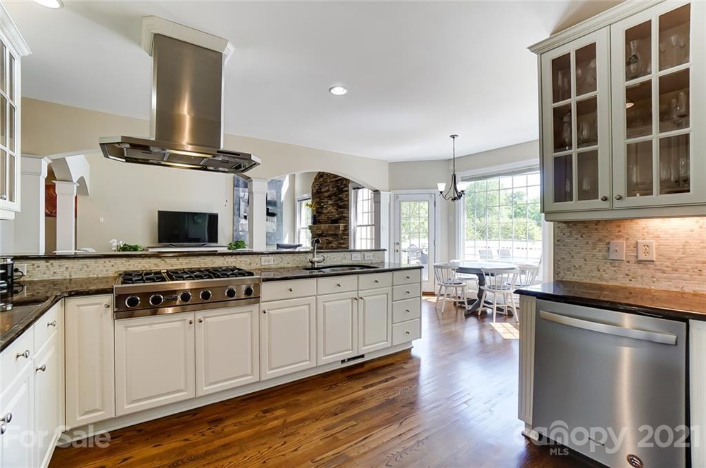 7126 Topsail Circle Tega Cay, SC 29708 - Photo 16 of 48 a kitchen with stainless steel appliances a stove and white cabinets