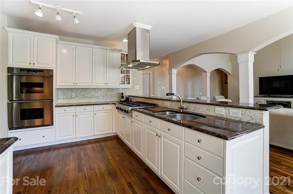 7126 Topsail Circle Tega Cay, SC 29708 - Photo 17 of 48 a kitchen with granite countertop a sink and a stove top oven