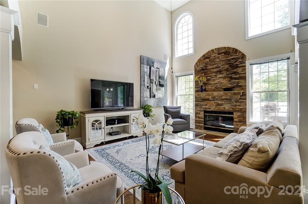 7126 Topsail Circle Tega Cay, SC 29708 - Photo 23 of 48 a living room with furniture a flat screen tv and a fireplace
