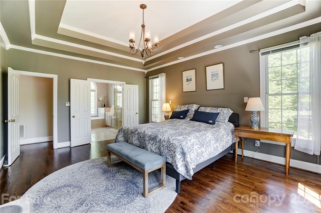 7126 Topsail Circle Tega Cay, SC 29708 - Photo 25 of 48 a spacious bedroom with a bed and wooden floor
