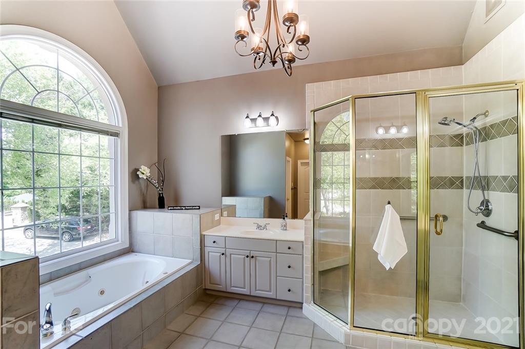 7126 Topsail Circle Tega Cay, SC 29708 - Photo 27 of 48 a bathroom with a tub sink shower and mirror