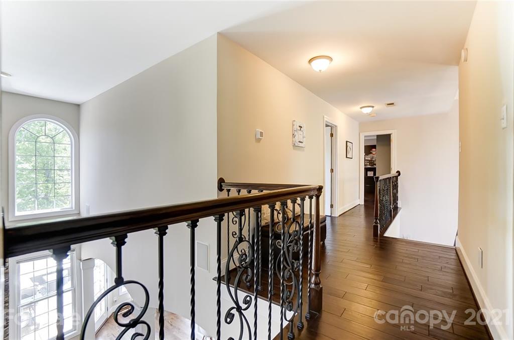 7126 Topsail Circle Tega Cay, SC 29708 - Photo 29 of 48 a view of a hallway with wooden floor and windows