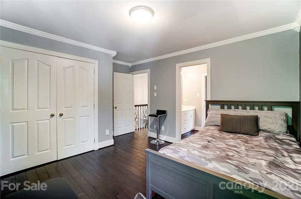 7126 Topsail Circle Tega Cay, SC 29708 - Photo 32 of 48 a bedroom with a bed and wooden floor