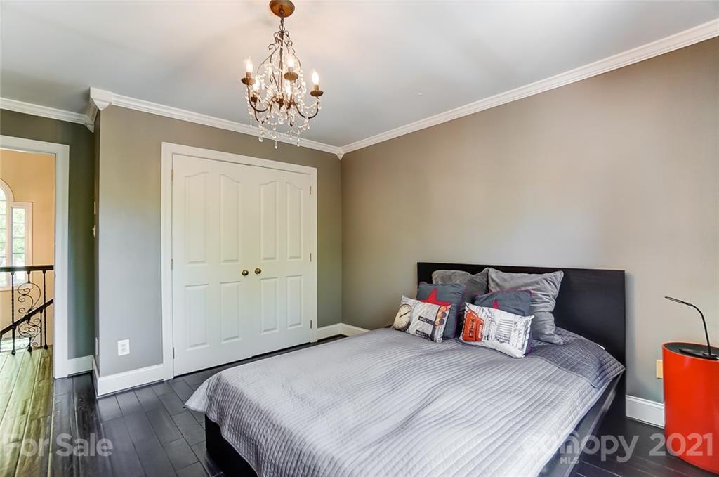 7126 Topsail Circle Tega Cay, SC 29708 - Photo 35 of 48 a bedroom with a bed and a chandelier