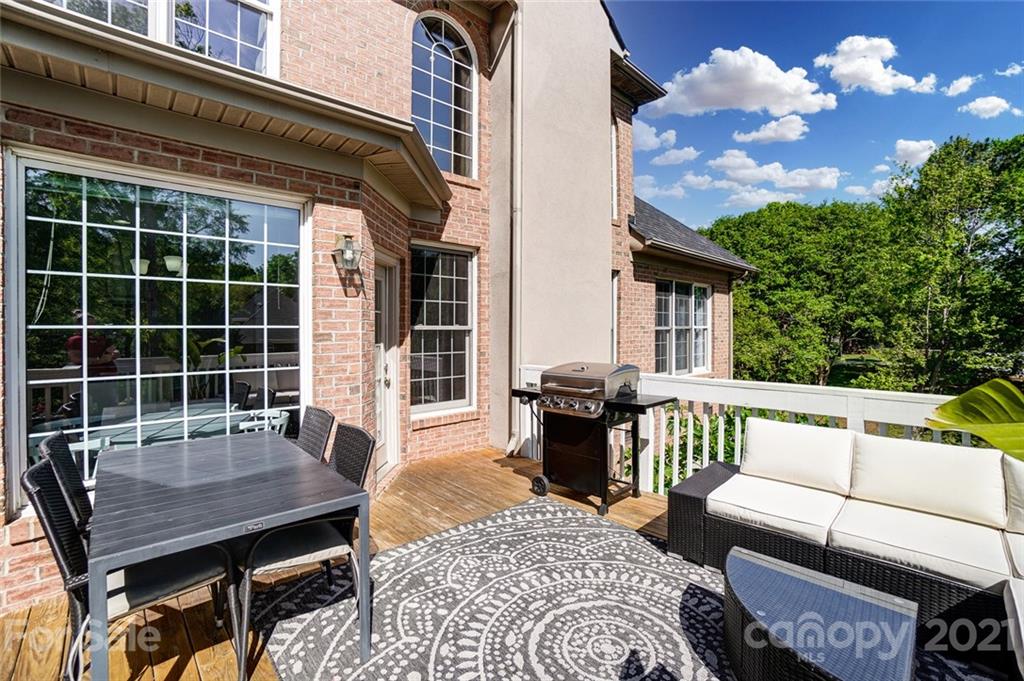 7126 Topsail Circle Tega Cay, SC 29708 - Photo 41 of 48 a view of a patio with a dining table and chairs with wooden floor