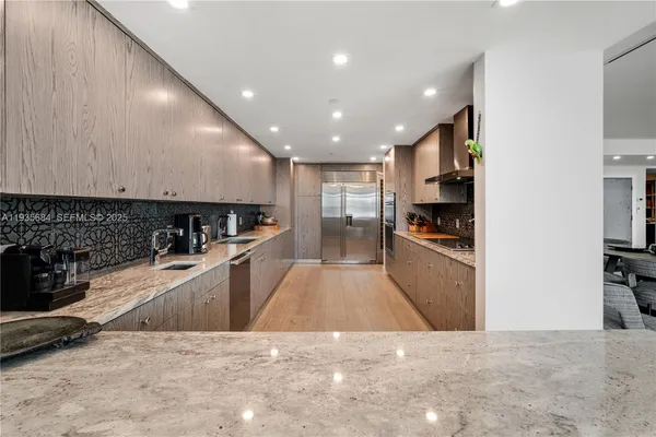 a kitchen with a refrigerator and a counter top space