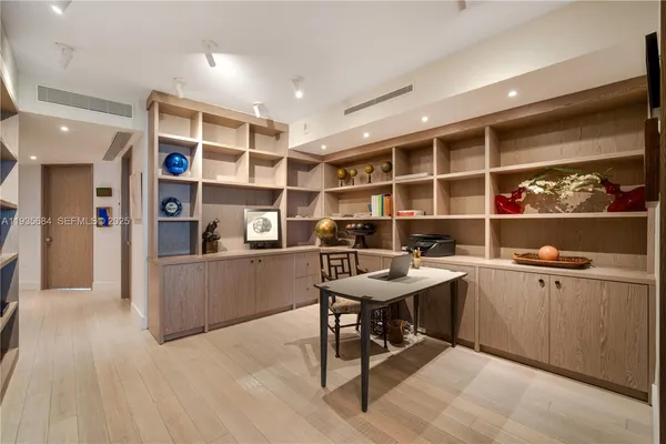 a room with a workspace and a bookshelf