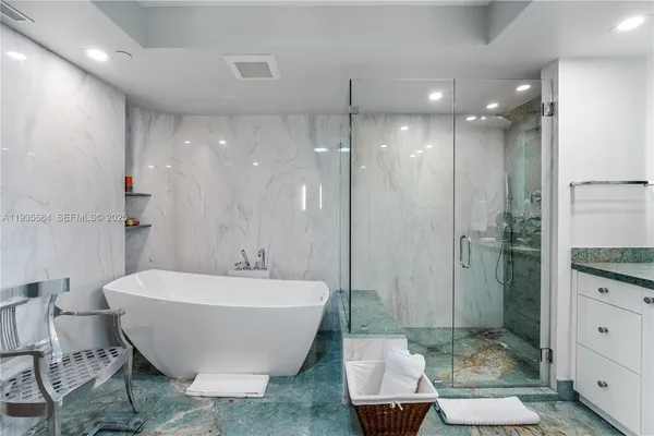 a spacious bathroom with a bathtub and shower