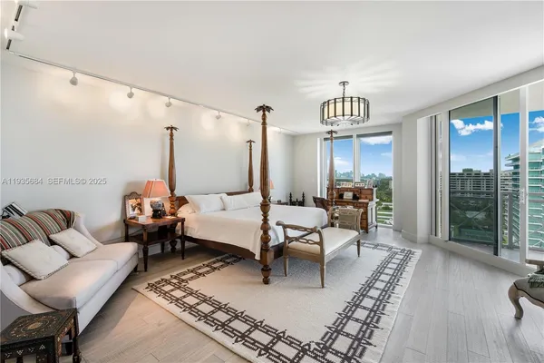 a living room with furniture floor to ceiling window and wooden floor