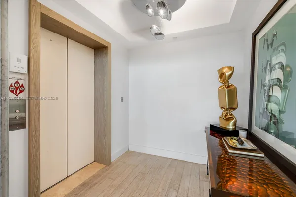 a view of a hallway with wooden floor and stairs