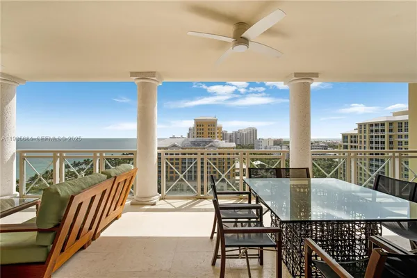 a view of a balcony with table and chairs