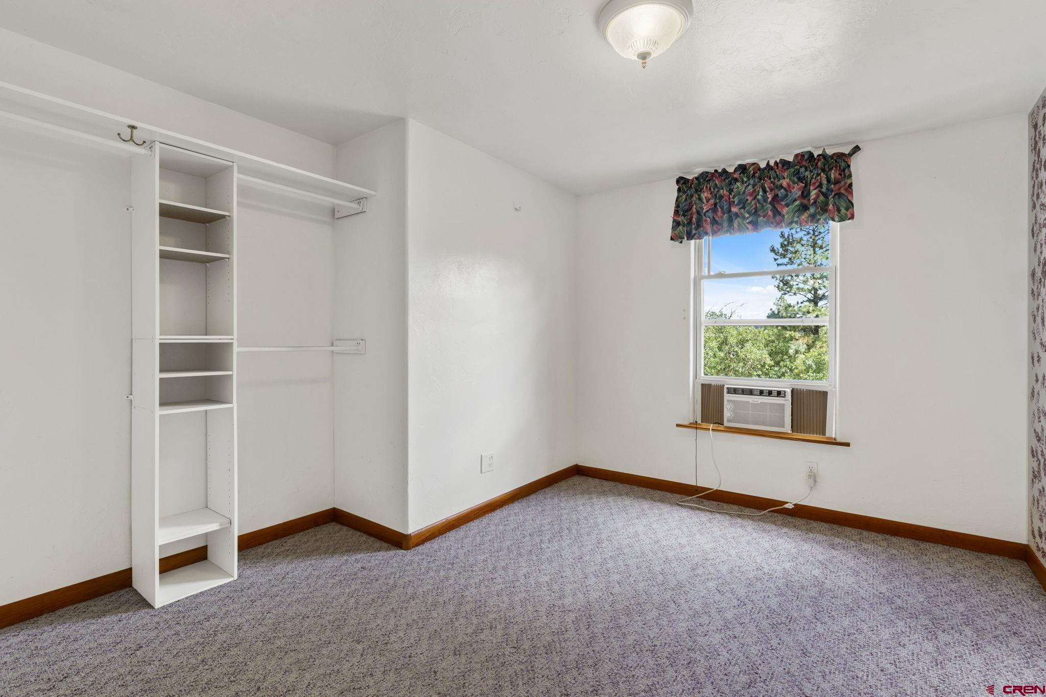 564 Spring Road Durango, CO 81303 - Photo 14 of 45 an empty room with windows and closet