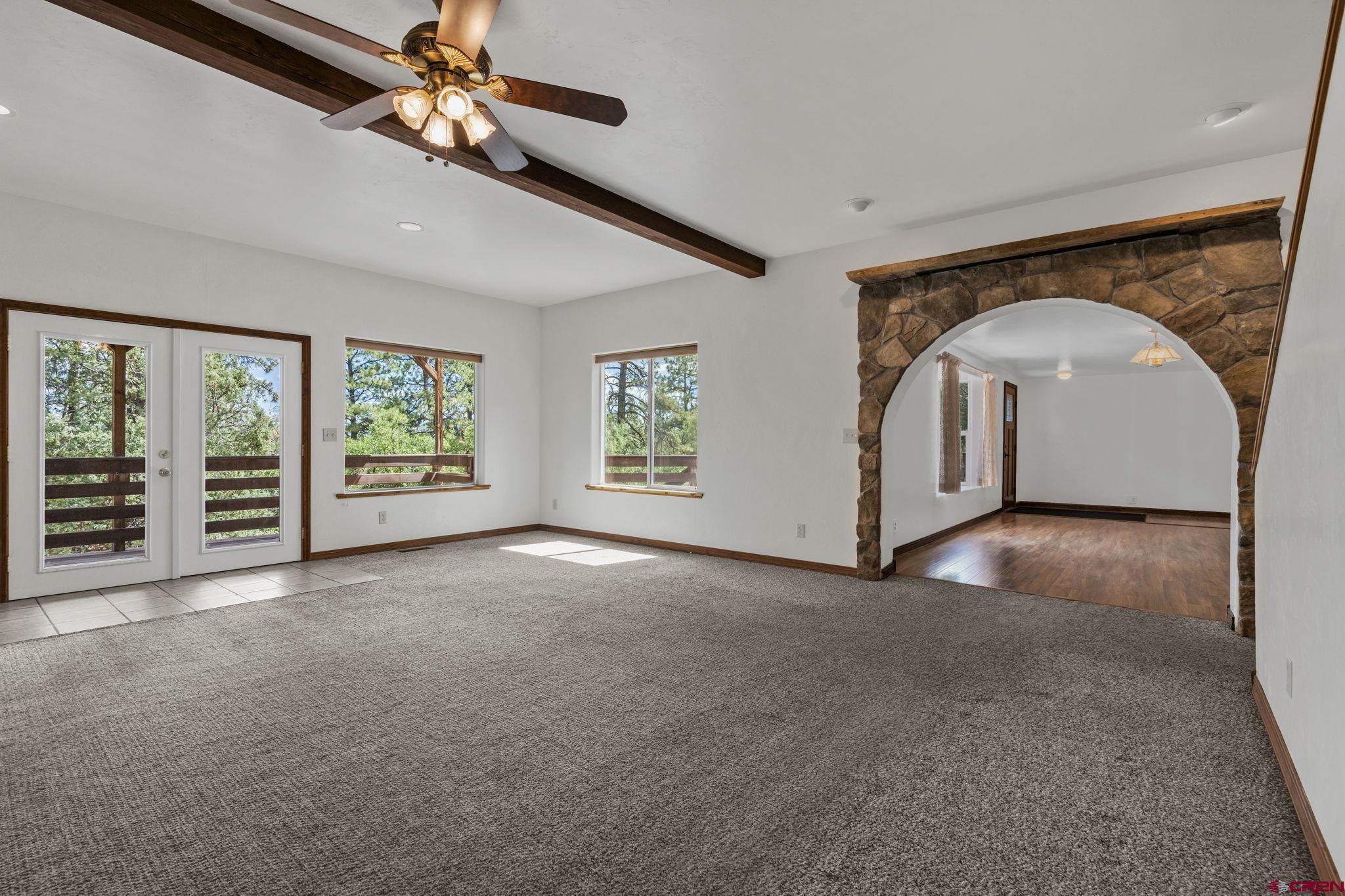564 Spring Road Durango, CO 81303 - Photo 21 of 45 an empty room with windows and ceiling fan