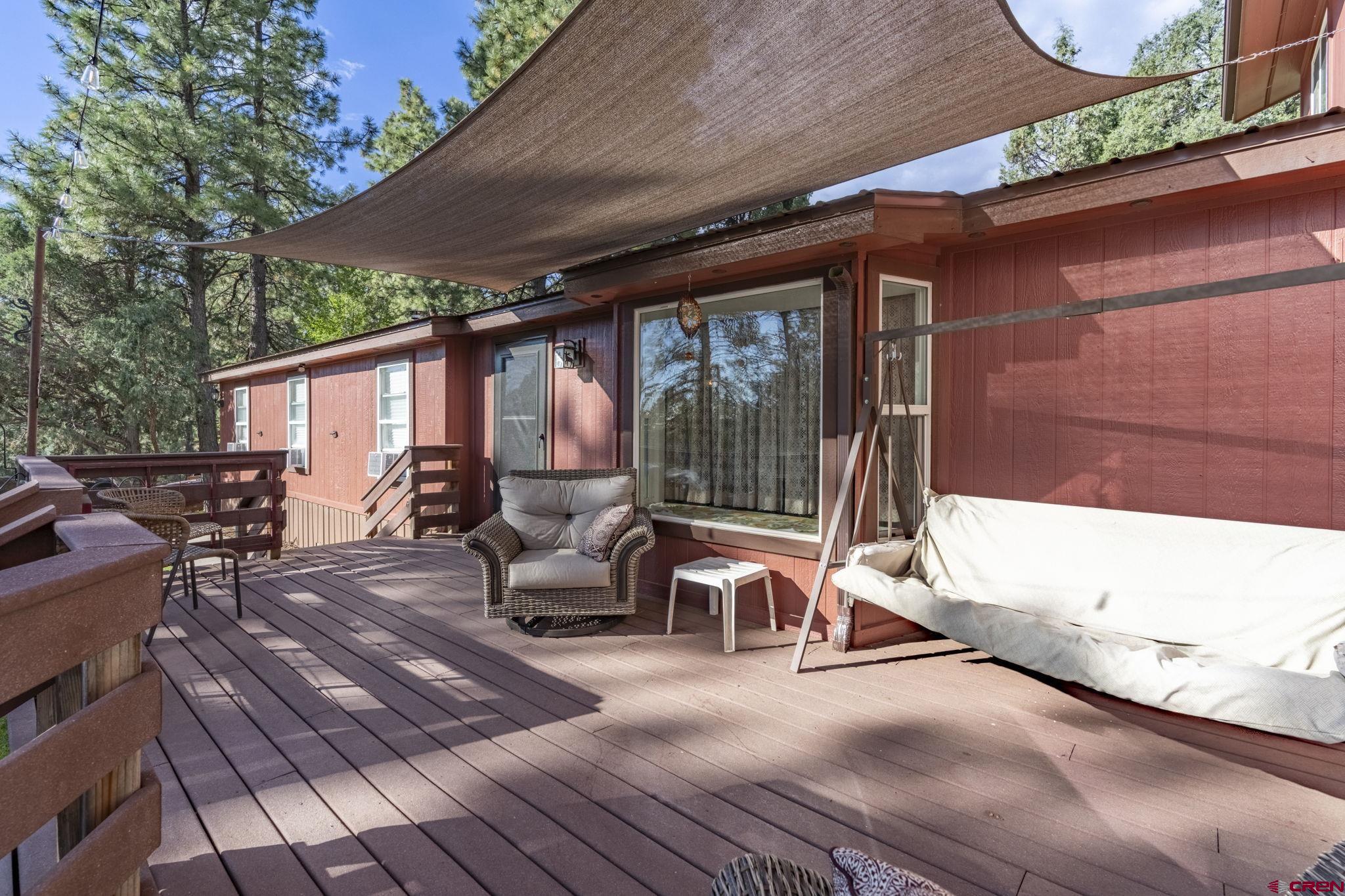 564 Spring Road Durango, CO 81303 - Photo 29 of 45 a view of a patio with table and chairs potted plants with wooden floor and fence