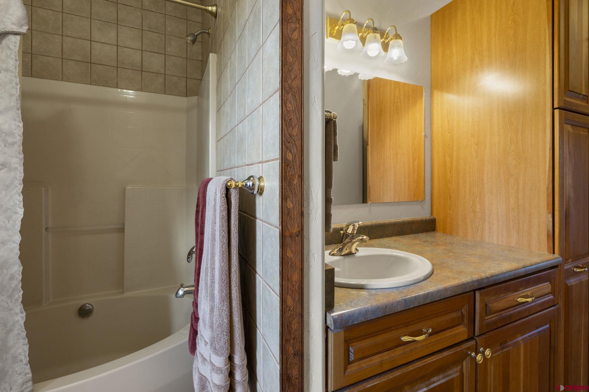 564 Spring Road Durango, CO 81303 - Photo 36 of 45 a bathroom with a granite countertop sink and a mirror