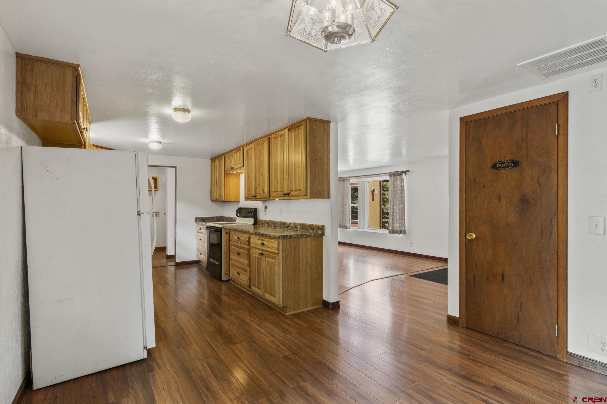 564 Spring Road Durango, CO 81303 - Photo 7 of 45 a view of kitchen with sink refrigerator and cabinets