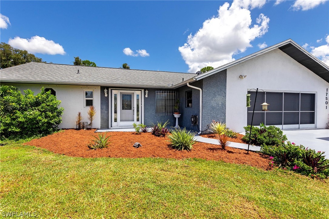 17501 Laurel Valley Road Fort Myers, FL 33967 - Photo 1 of 26 a front view of a house with a yard
