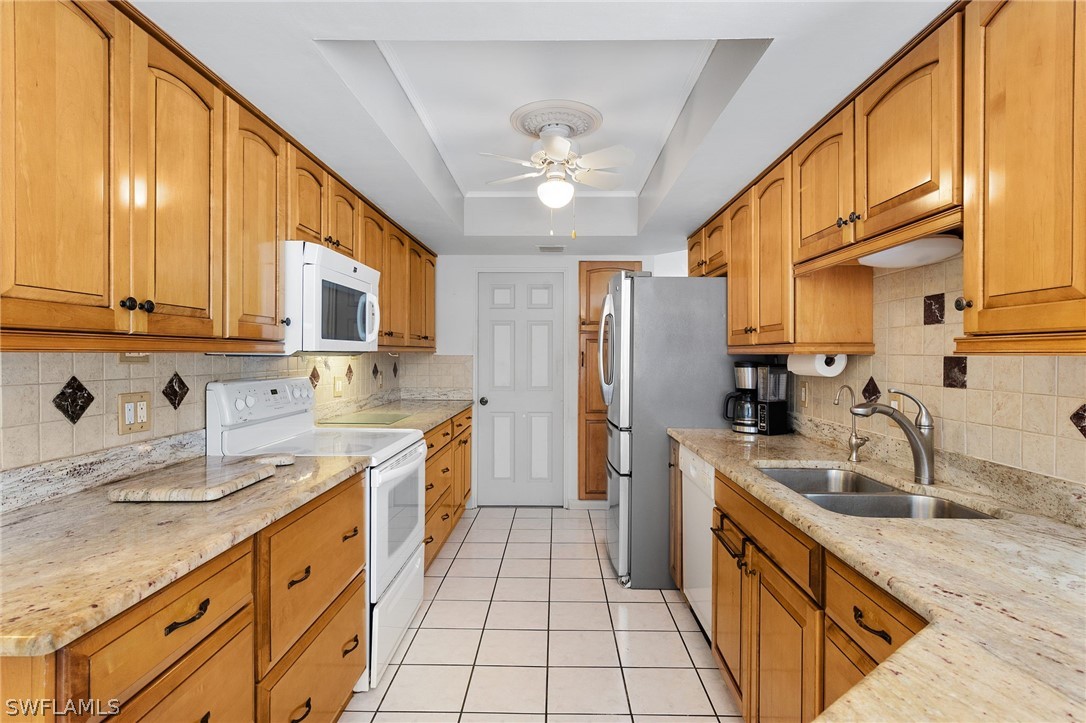 17501 Laurel Valley Road Fort Myers, FL 33967 - Photo 11 of 26 a kitchen with stainless steel appliances granite countertop a sink stove and refrigerator