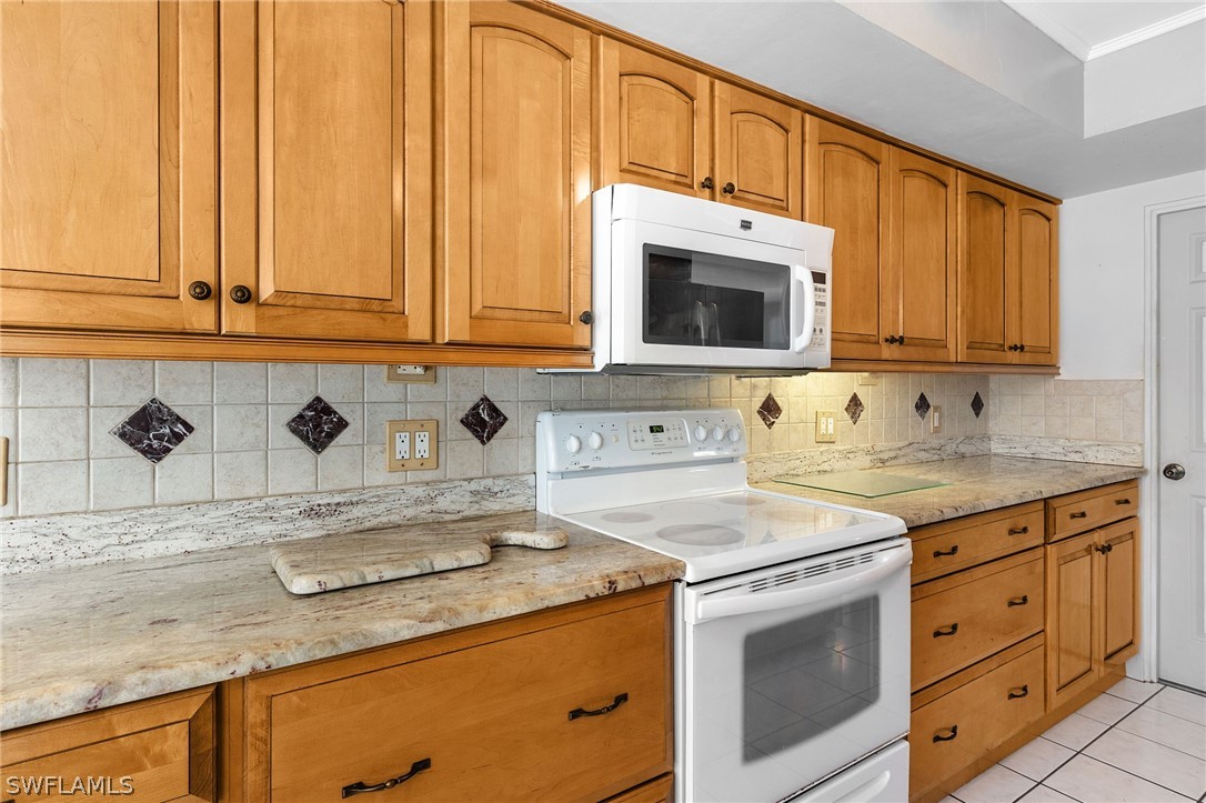 17501 Laurel Valley Road Fort Myers, FL 33967 - Photo 12 of 26 a kitchen with stainless steel appliances granite countertop a sink stove and cabinets