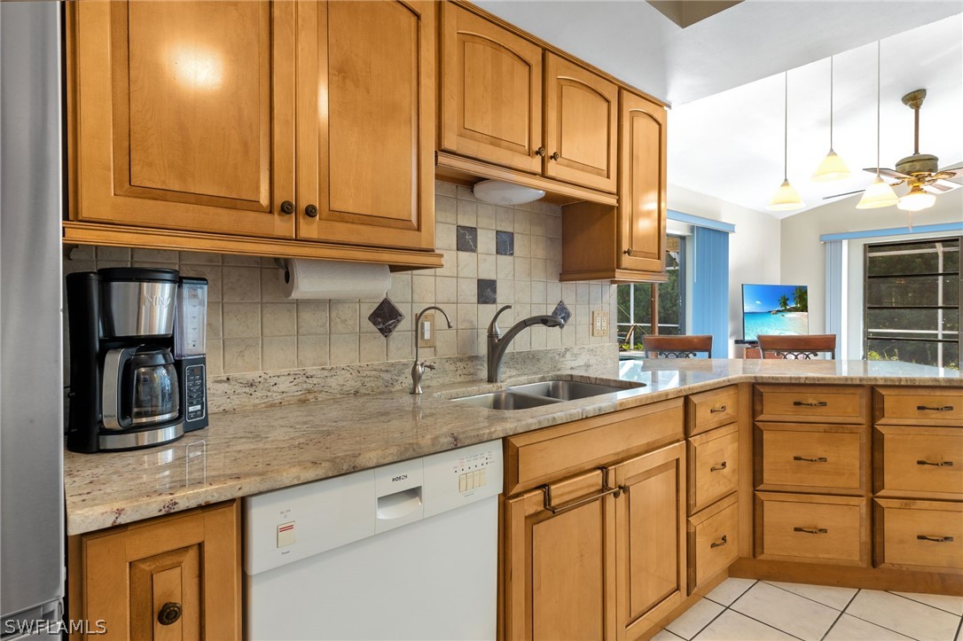 17501 Laurel Valley Road Fort Myers, FL 33967 - Photo 13 of 26 a kitchen with stainless steel appliances granite countertop a sink and cabinets