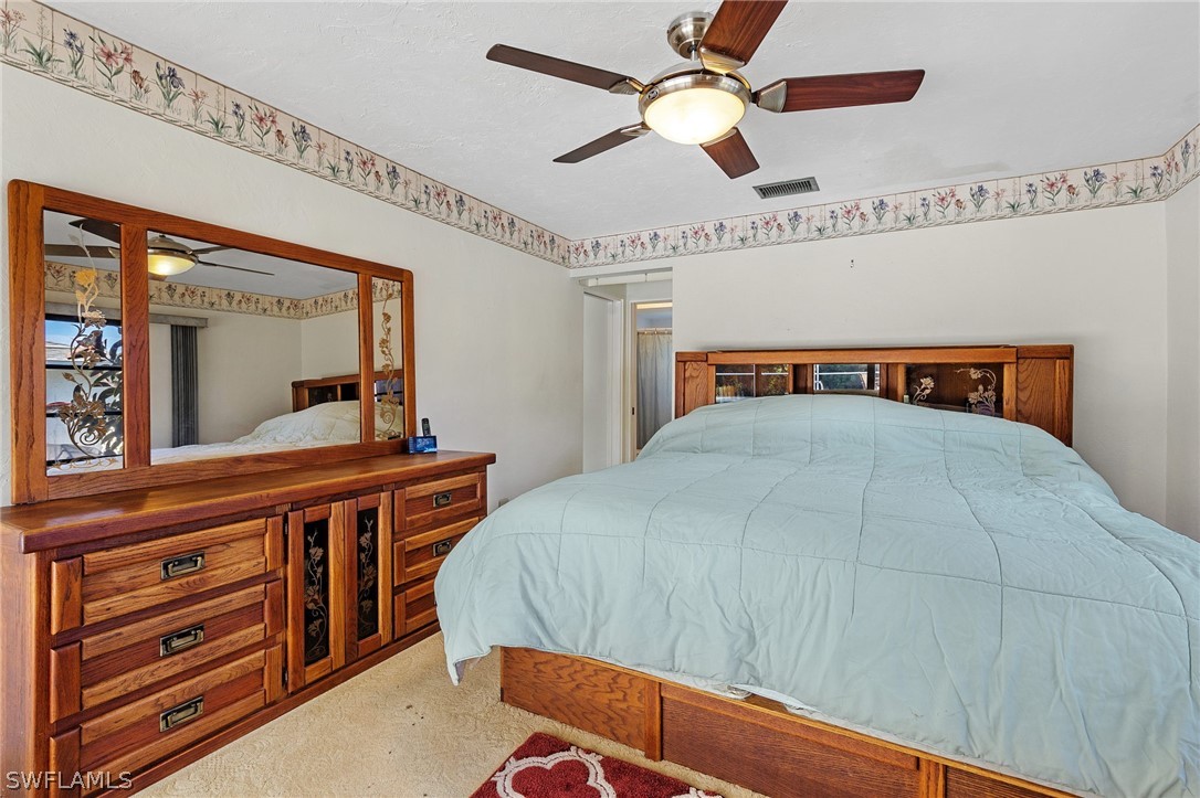 17501 Laurel Valley Road Fort Myers, FL 33967 - Photo 18 of 26 a bedroom with a bed and a large dresser