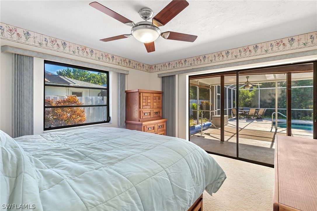 17501 Laurel Valley Road Fort Myers, FL 33967 - Photo 19 of 26 a bedroom with a large bed and a large window