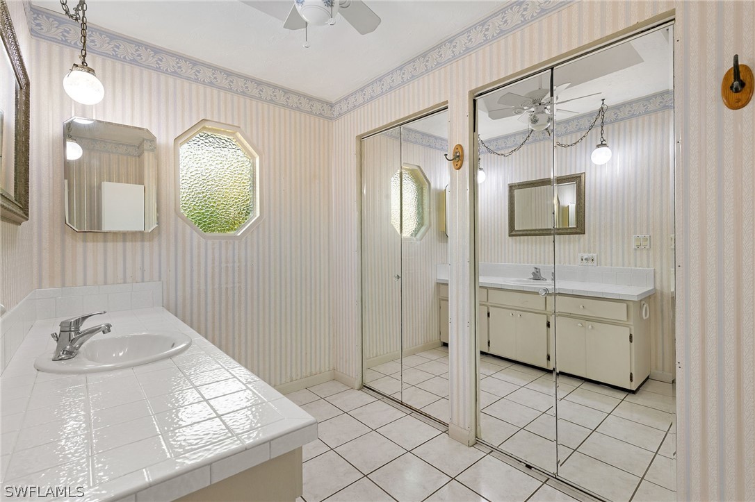 17501 Laurel Valley Road Fort Myers, FL 33967 - Photo 20 of 26 a bathroom with a double vanity sink mirror and toilet