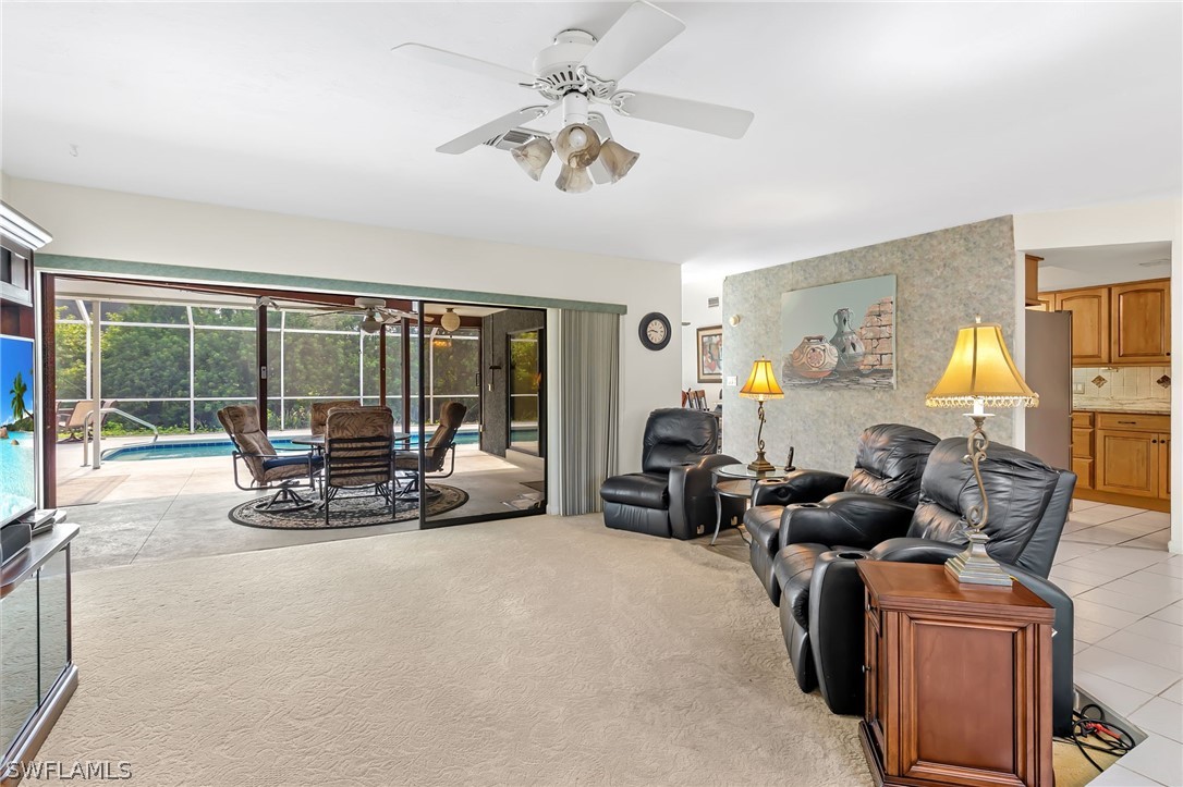 17501 Laurel Valley Road Fort Myers, FL 33967 - Photo 5 of 26 a living room with furniture and a large window with garden view