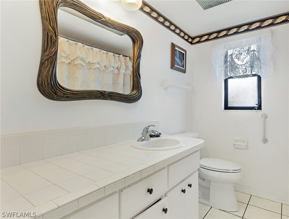 17501 Laurel Valley Road Fort Myers, FL 33967 - Photo 8 of 26 a bathroom with a sink and a mirror