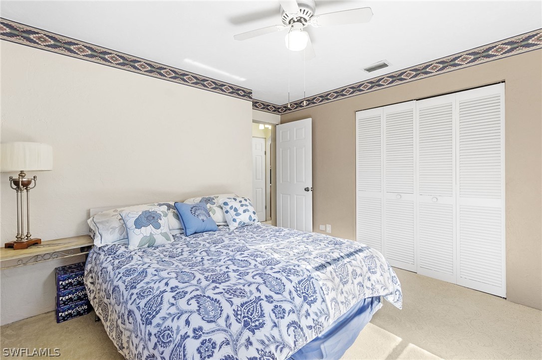 17501 Laurel Valley Road Fort Myers, FL 33967 - Photo 9 of 26 a bedroom with a bed and a mirror