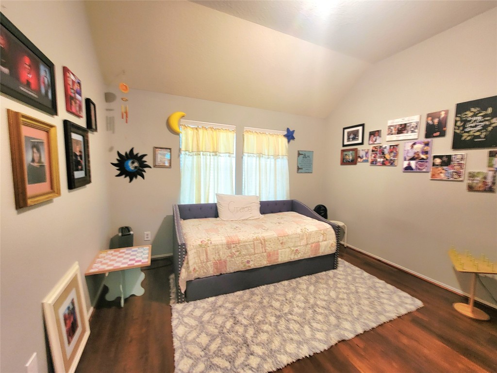 219 Golden Grain Drive Rosenberg, TX 77469 - Photo 11 of 17 a bedroom with a bed and a table in it