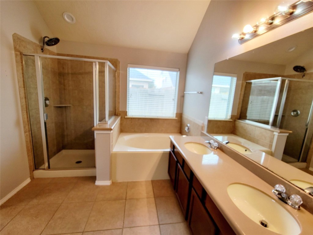 219 Golden Grain Drive Rosenberg, TX 77469 - Photo 12 of 17 a bathroom with a tub sink and mirror