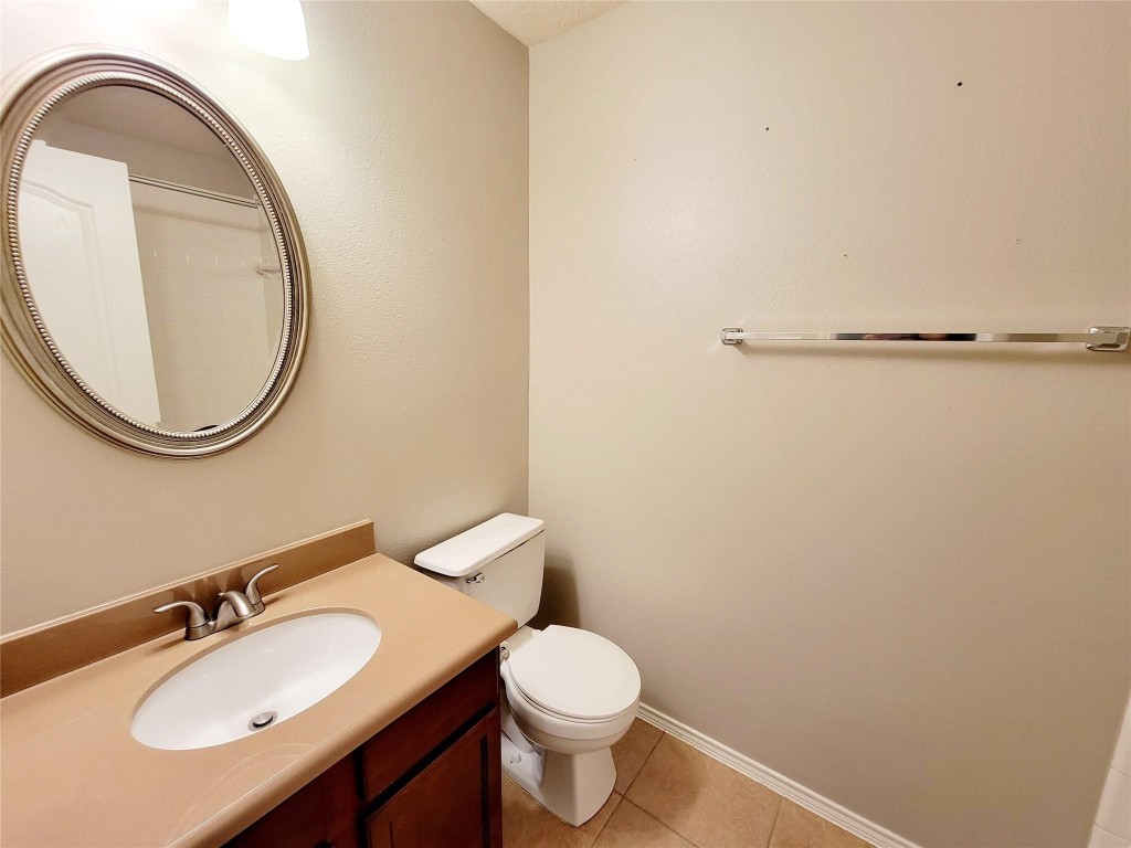 219 Golden Grain Drive Rosenberg, TX 77469 - Photo 4 of 17 a bathroom with a granite countertop toilet sink and mirror