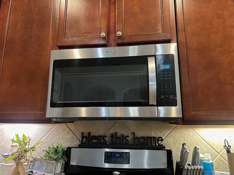 219 Golden Grain Drive Rosenberg, TX 77469 - Photo 6 of 17 a kitchen with a stove and a microwave