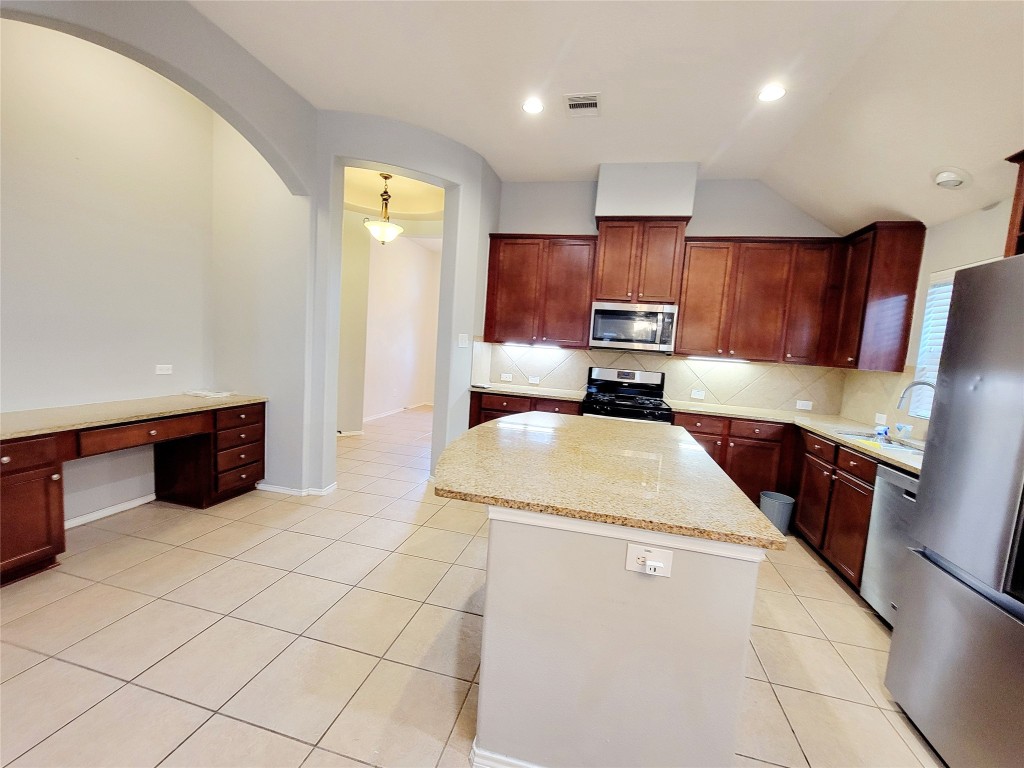 219 Golden Grain Drive Rosenberg, TX 77469 - Photo 7 of 17 a kitchen with stainless steel appliances a refrigerator sink and stove
