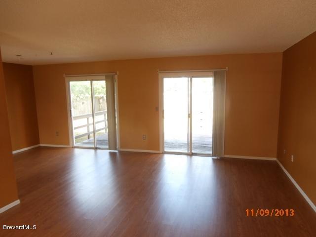 265 Benchor Road Northwest Palm Bay, FL 32907 - Photo 3 of 14 an empty room with wooden floor and windows