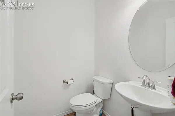 a bathroom with a sink a toilet and a mirror